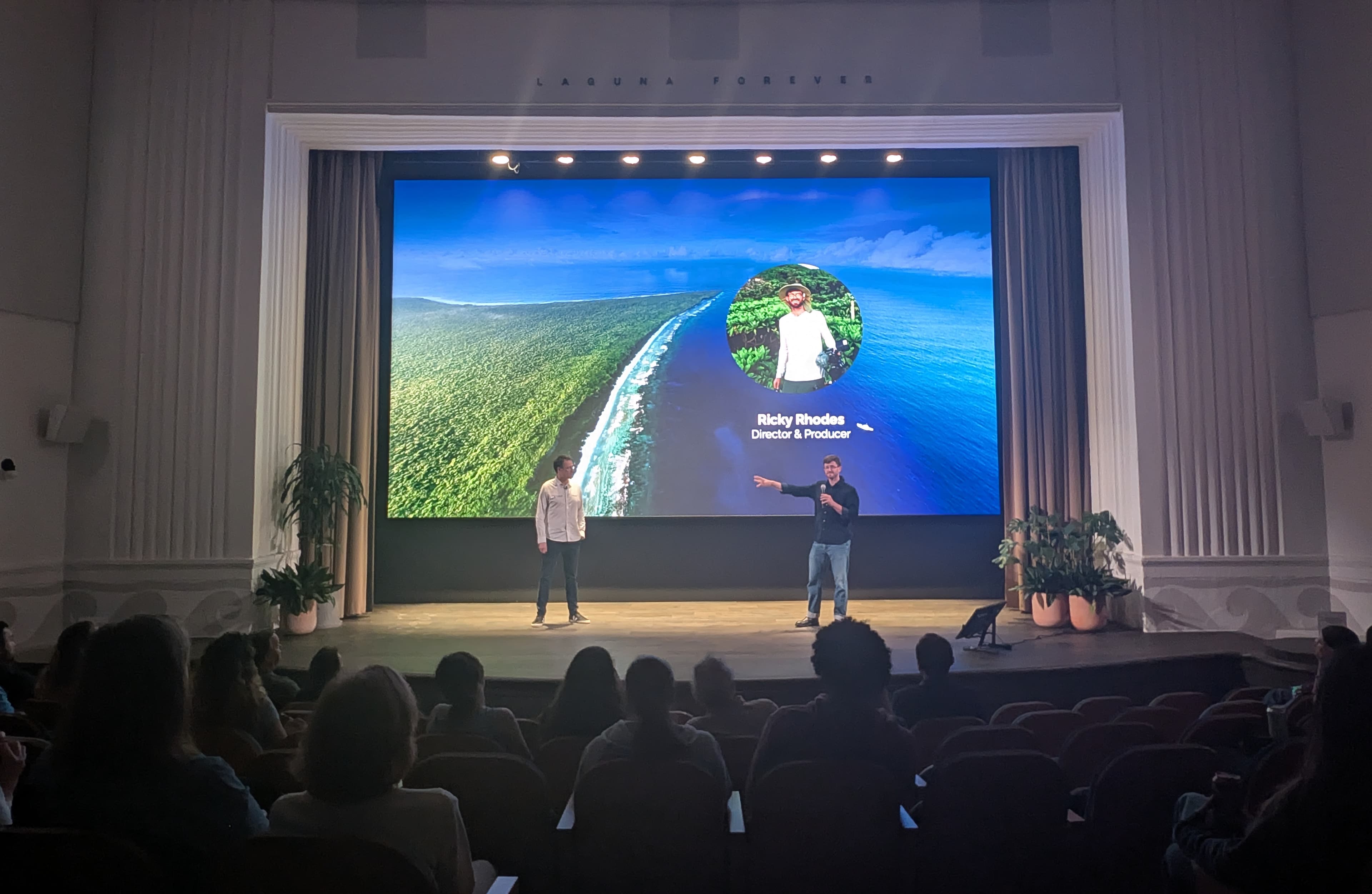 Ricky Rhodes speaking at LA Climate Week 2026 at the Rivian South Coast Theater, with the Impossible Cleanups slide behind him