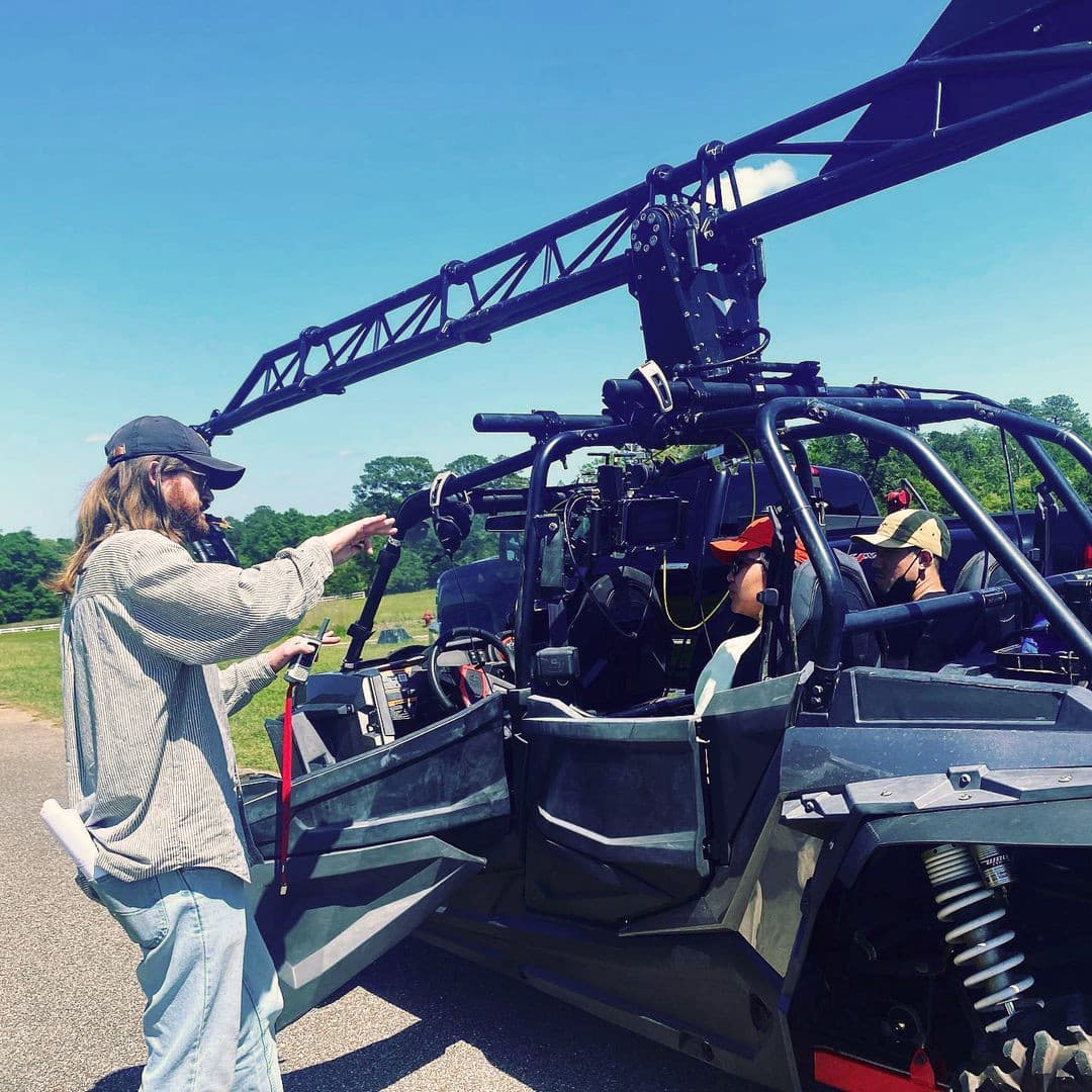 Ricky Rhodes directing on the Yellow Wallpaper set, beside a vehicle-mounted camera rig